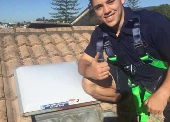RTL Tradesmen poses next to newly installed skylight RTL Tradesmen poses next to newly installed skylight